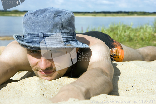 Image of man lying on a beach