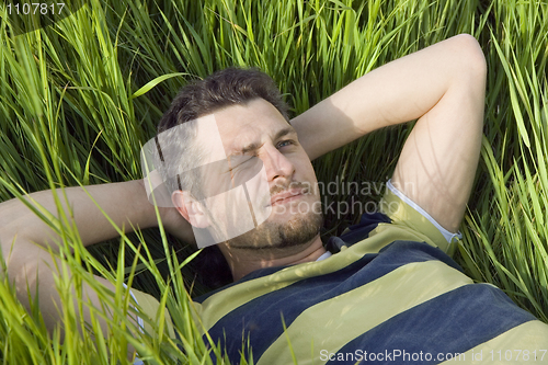 Image of The man lies on a grass