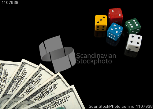 Image of Colorful dices and money on black background