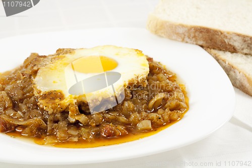 Image of Stew with baked onion, egg and meat