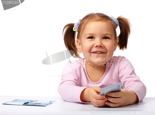 Image of Little girl with few paper euro banknotes