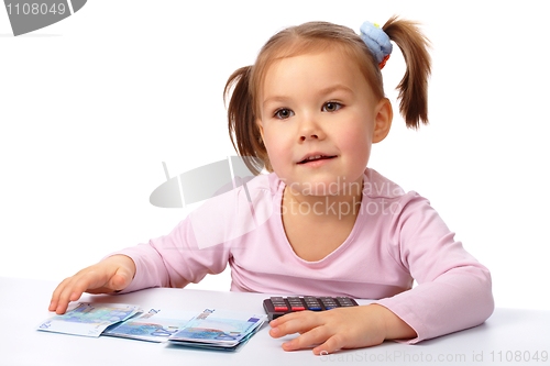 Image of Little girl with few paper euro banknotes