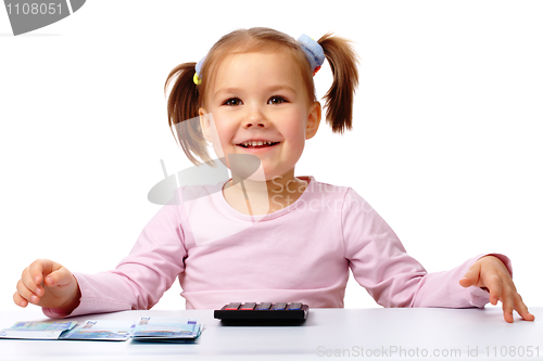 Image of Little girl with few paper euro banknotes