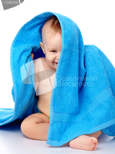 Image of Cute child wrapped in blue towel