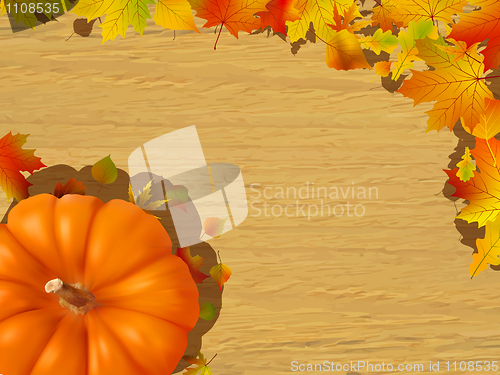 Image of Fall leaves making a border with pumpkin