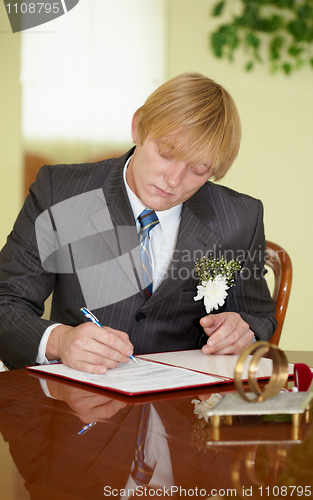 Image of Groom solemnly signed documents