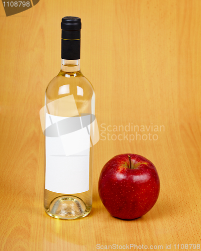 Image of Bottle of cider on wooden table