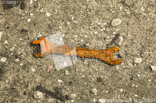 Image of Old rusty wrench on ground