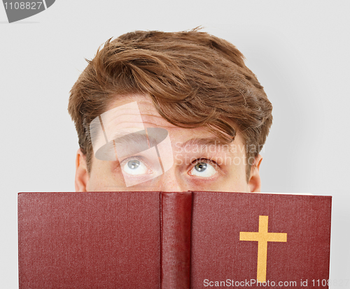 Image of Young man thinks after bible reading