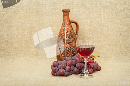 Image of Still-life from a clay bottle, grapes and wine