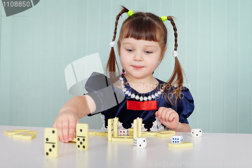 Image of Little girl playing with dominoes