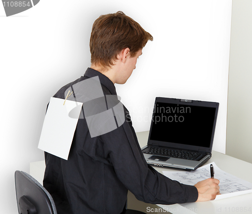 Image of Man busy with work. On back attached piece of paper