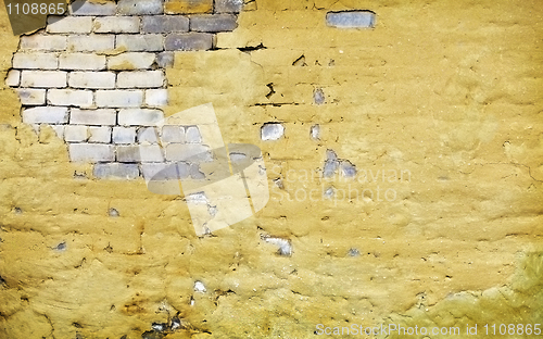 Image of Brick wall with broken plaster