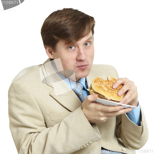 Image of Funny businessman eats a sandwich isolated on a white
