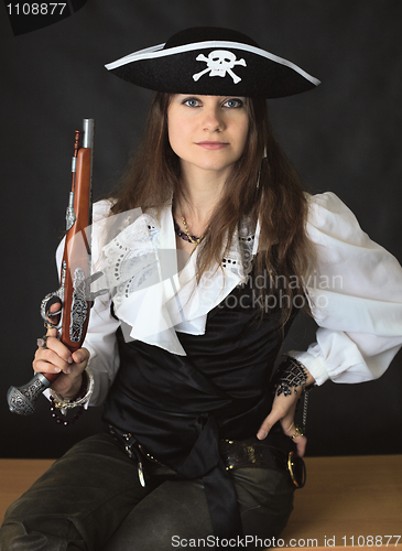 Image of Young beautiful girl - sea pirate with pistol