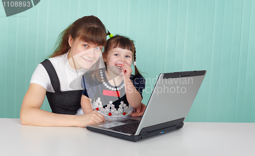 Image of Mom and daughter playing with laptop