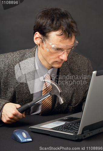 Image of Person repairs laptop as is able