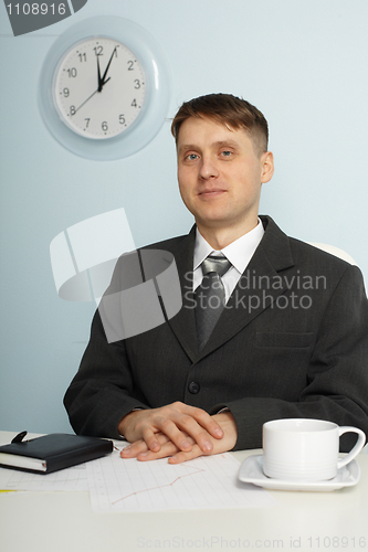 Image of Young chief sitting on workplace