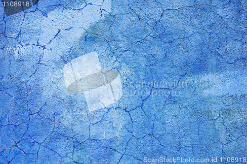 Image of Blue wall covered with cracked plaster