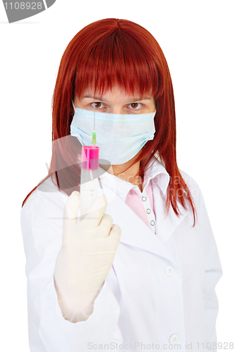 Image of Young woman - doctor armed with large syringe