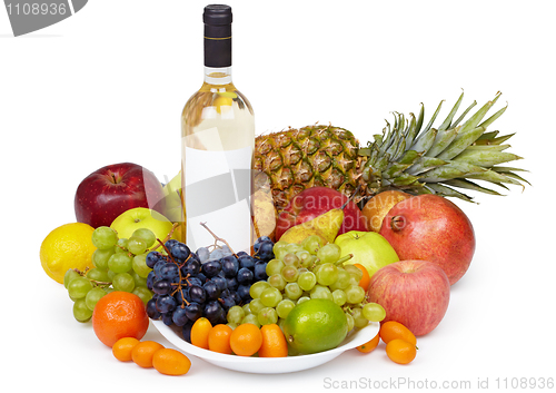 Image of Still life - tropical fruits and bottle of wine