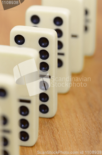 Image of Dominoes on wooden surface abreast