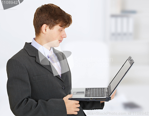 Image of Engineer works with laptop on hands