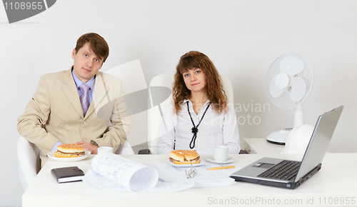 Image of Businessmen prepare for a dinner sitting at a table