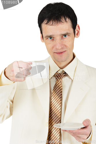 Image of Man dressed in suit drinking tea on white background