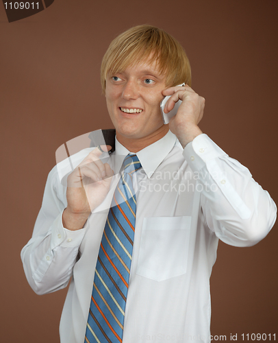 Image of Young man talks by mobile phone