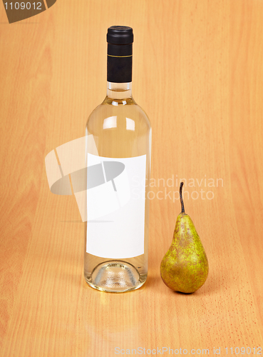 Image of Bottle of pear wine on wooden background