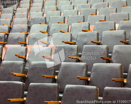 Image of Rows of old theater seats covered with leather