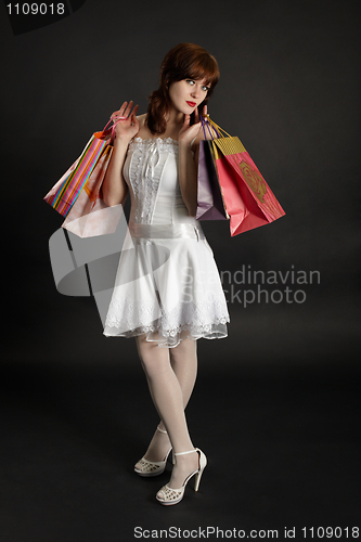 Image of Beautiful young woman with purchases