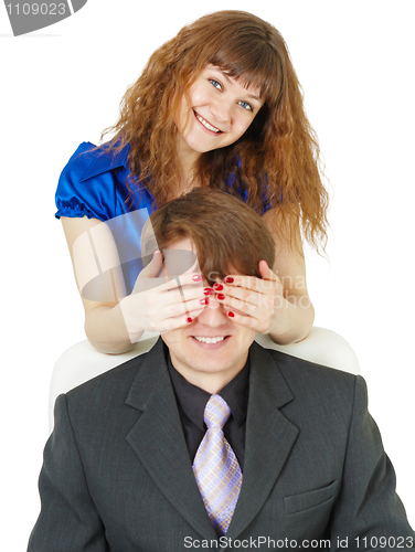 Image of Playful woman covered eyes of man