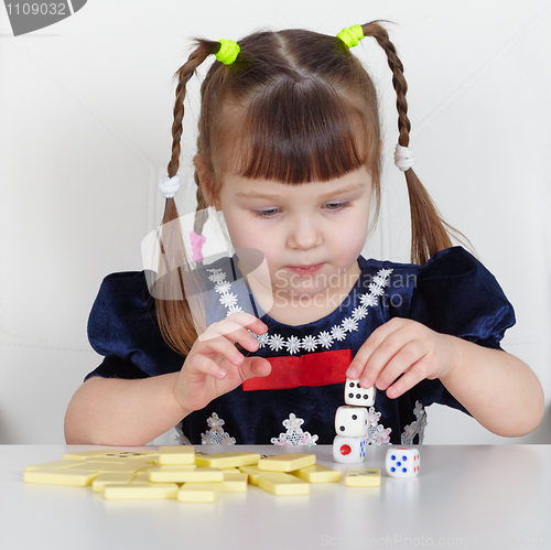 Image of Child playing with small toys at table