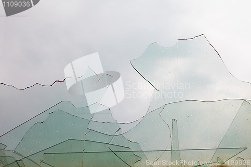 Image of View from window through old broken glass