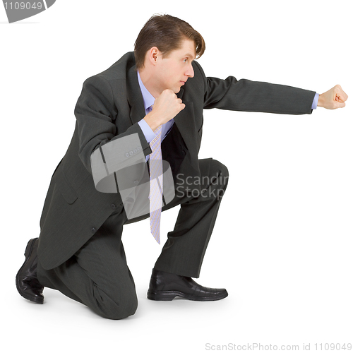 Image of Young man hits fist from seated position