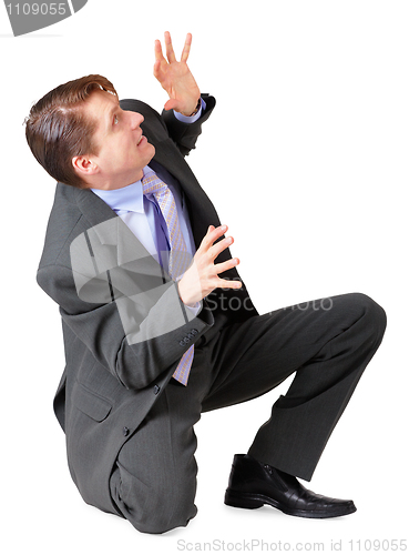 Image of Young man scared and sat on white background