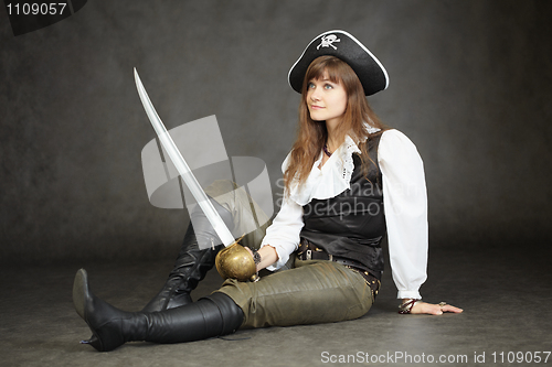 Image of Woman - captain of pirates sitting on black background with a sa