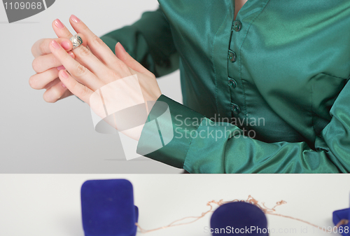 Image of Woman tries on jewels