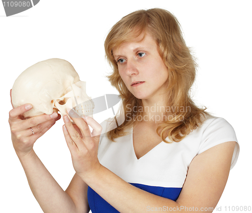 Image of Student watches plastic human skull