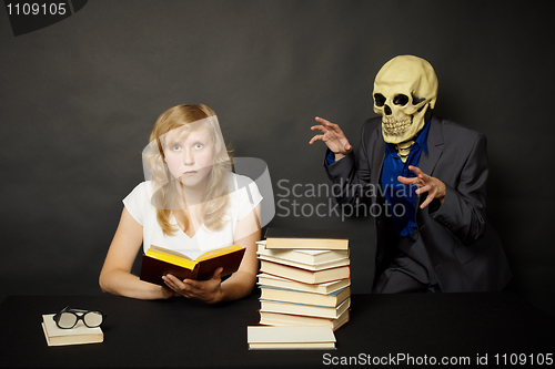 Image of Woman reading a terrible book in dark