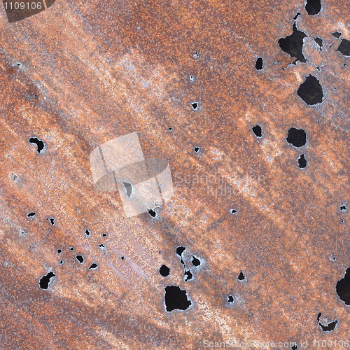 Image of Iron sheet with rust and through holes