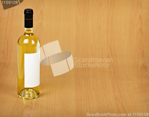 Image of Bottle of white wine on wooden table