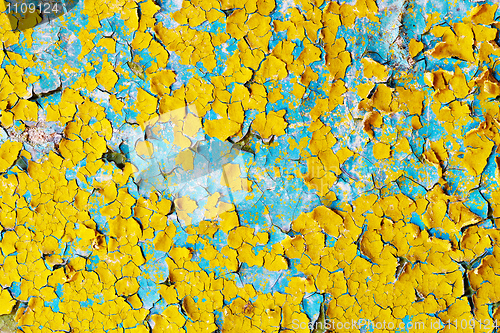 Image of Surface of cracked paint blue and yellow