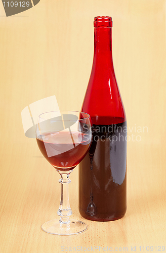 Image of Bottle of red wine and full glass