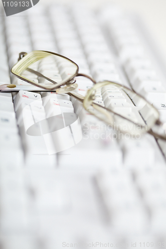 Image of Spectacles on computer keyboard - poor eyesight