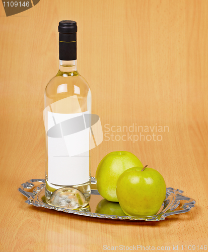 Image of Apple wine in closed bottle on tray