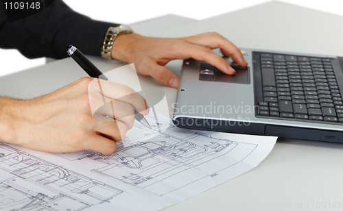 Image of Working on project with drawings and computer