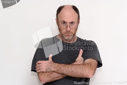 Image of Unshaved disheveled man in spectacles frowning